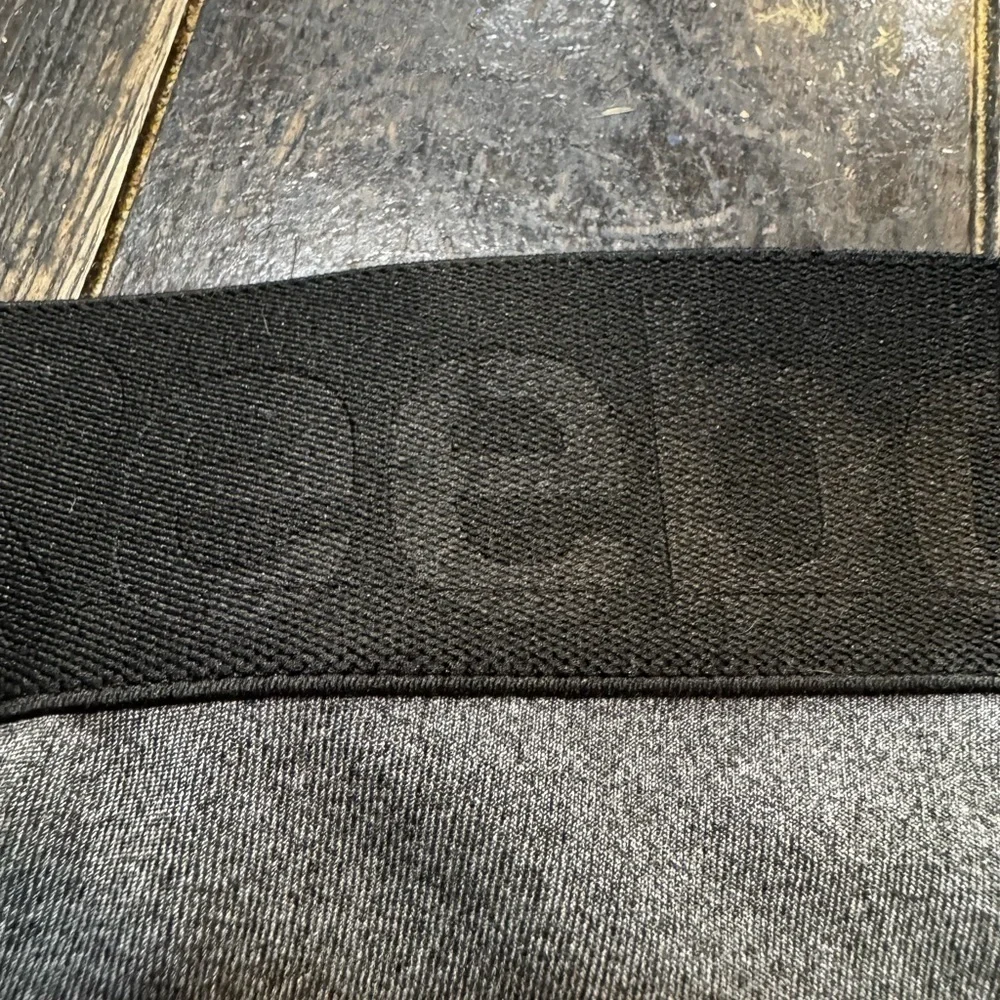 Reebok charcoal gray athletic leggings, mesh patterned detailing on side, S.
